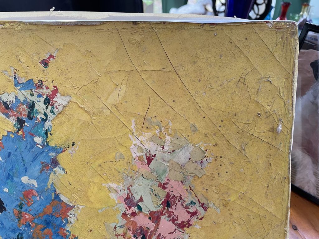 Abstract artwork with a textured yellow background and colorful paint splatters in various shades.