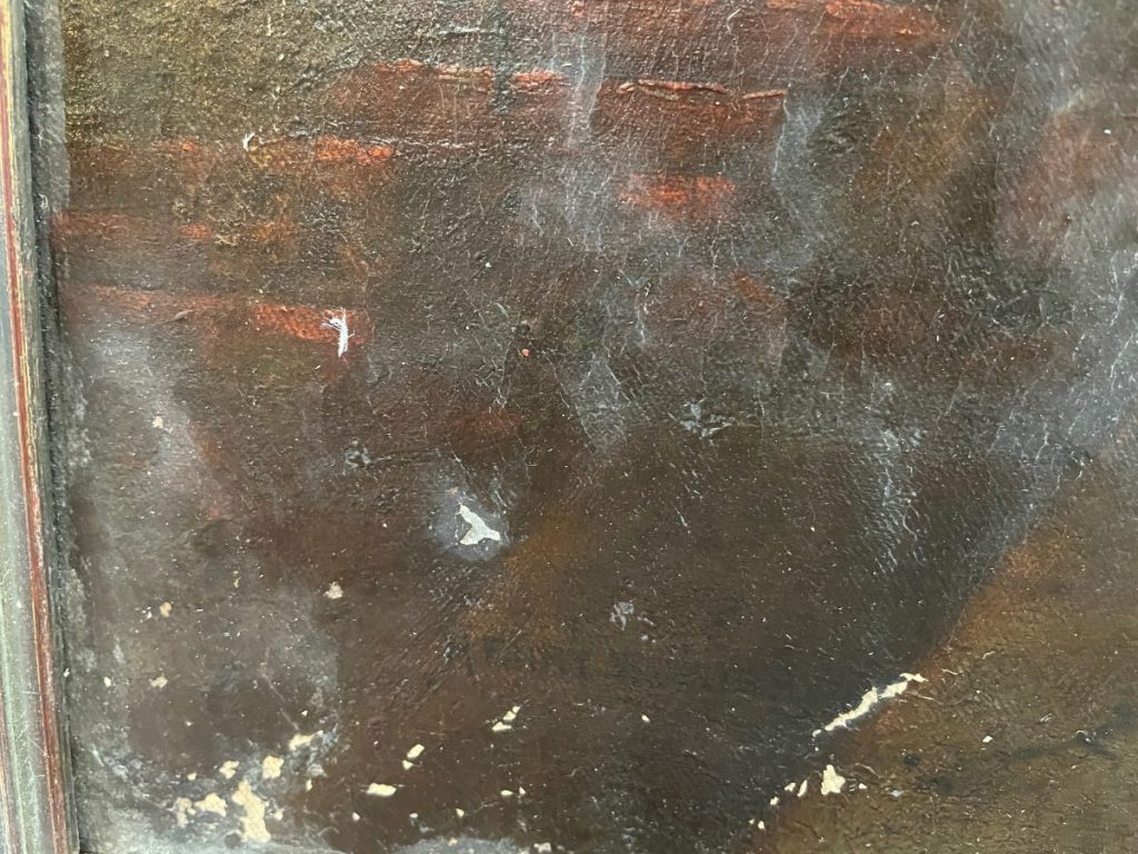 Close-up view of a textured dark surface with paint variations and imperfections.