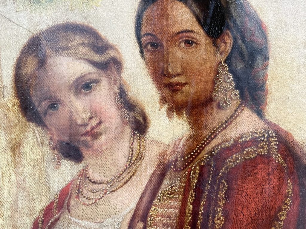 Close-up of a painting depicting two women wearing traditional attire and jewelry.