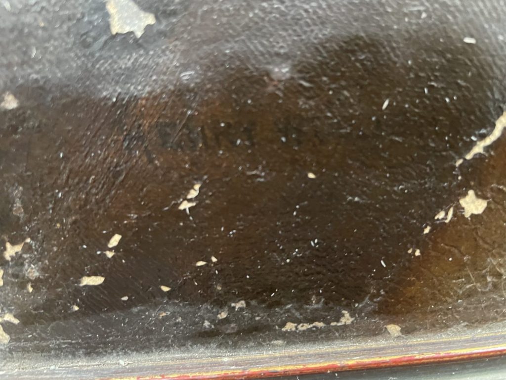 Close-up view of a textured surface with faint markings and scratches.