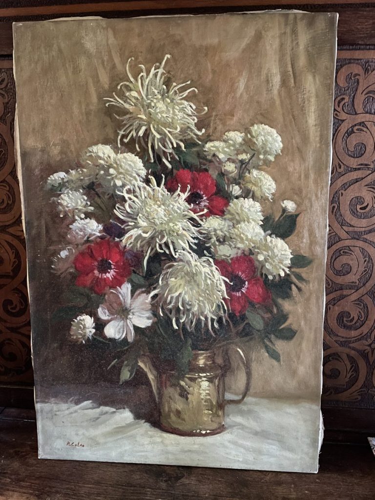 Still life painting featuring a bouquet of white and red flowers in a gold vase.
