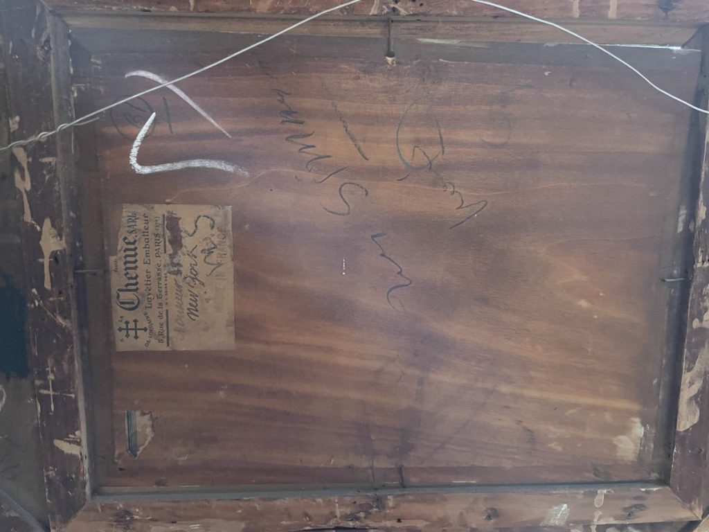 Back view of a wooden frame featuring a label and various signatures.