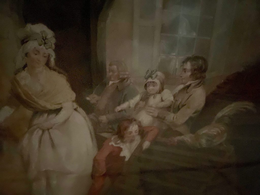 A family portrait featuring adults and children in a domestic setting.