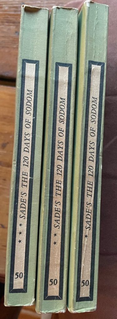 Three green hardcover volumes of Sade's The 120 Days of Sodom with black spine labels.