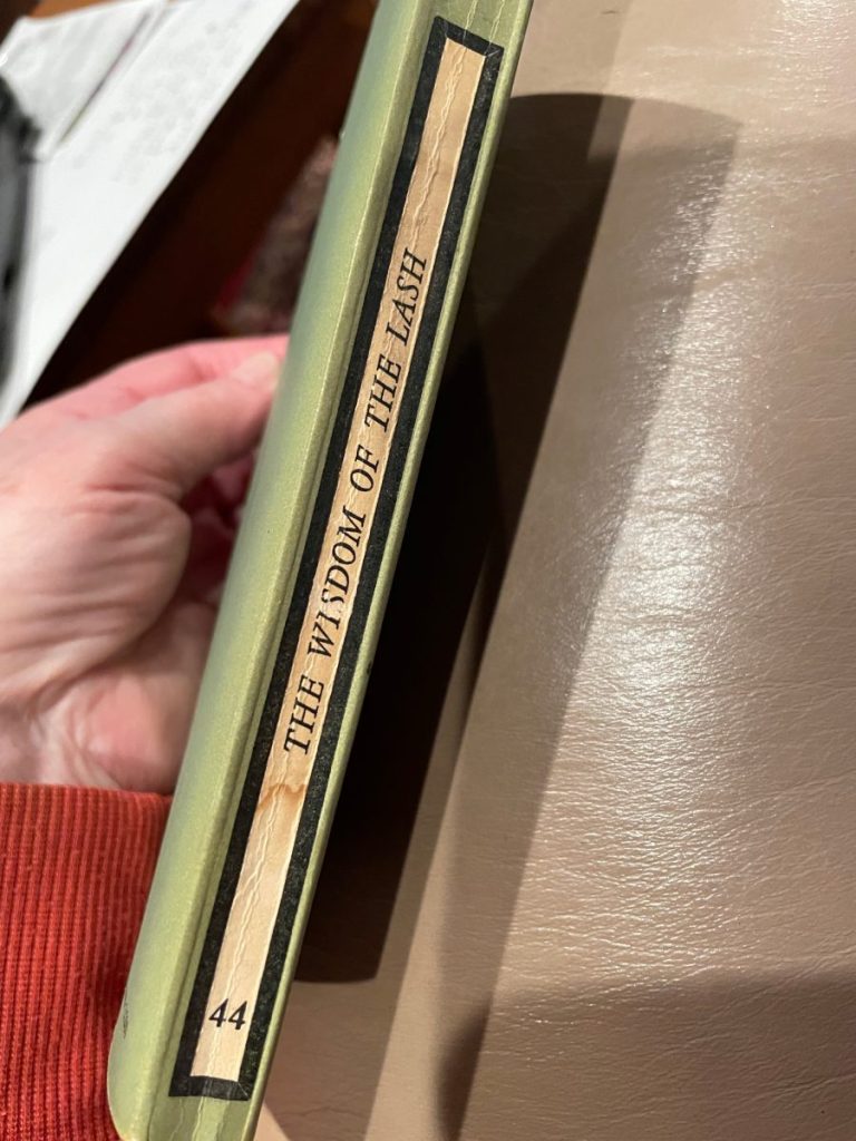 Book spine showing the title 'The Wisdom of the Lash' and the number 44.