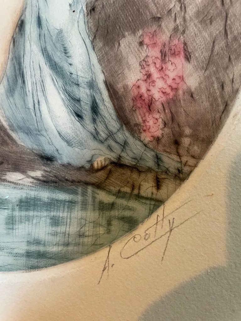 Close-up of an artistic piece showing a signature and colorful elements in the artwork.
