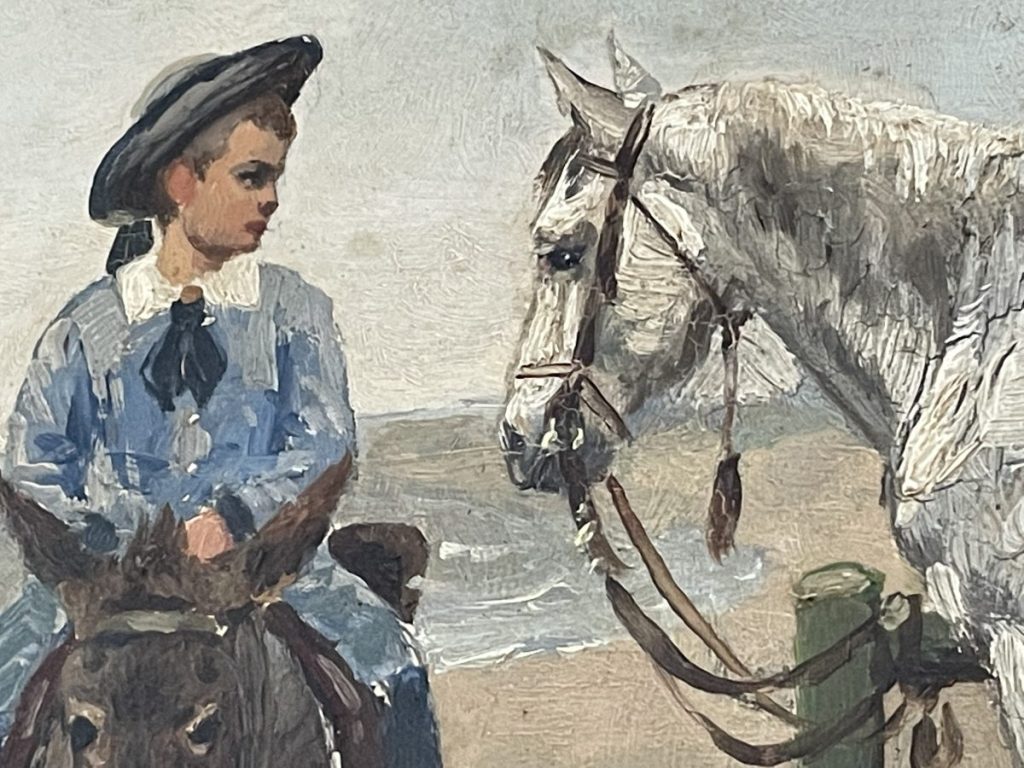 A young rider in a blue outfit sitting on a brown horse next to a white horse.