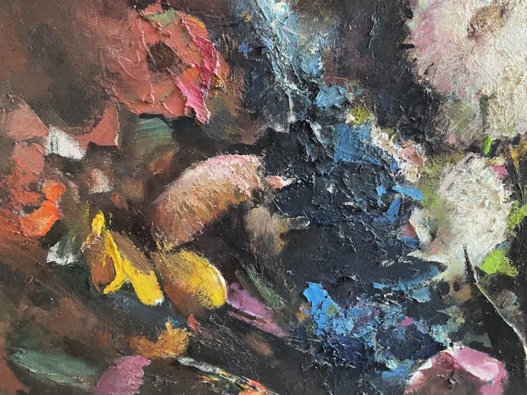 Close-up of an abstract oil painting featuring vibrant colors and floral shapes.