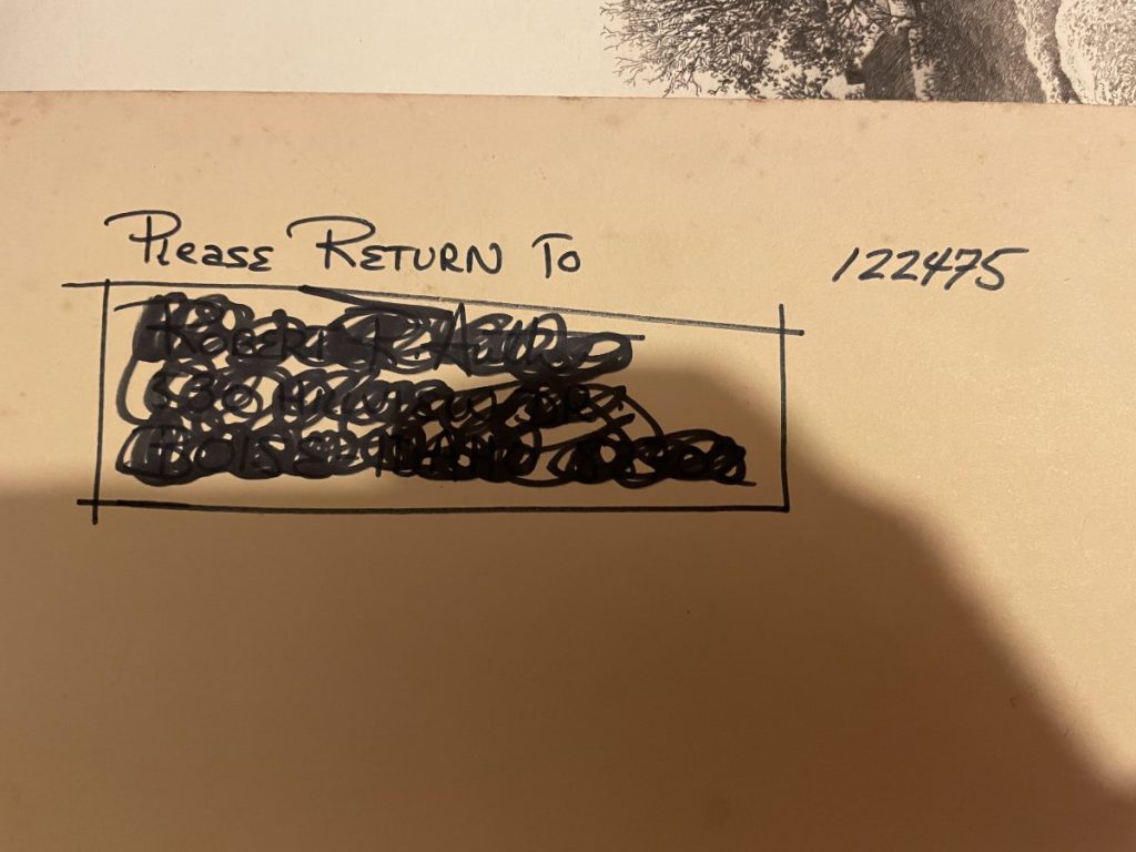 Handwritten note with instructions to return an item, featuring a blacked-out section and a number.