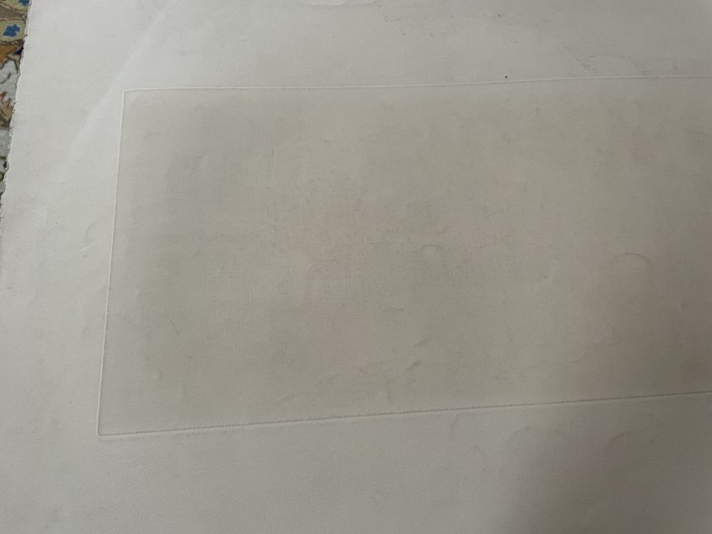 A plain white surface featuring a clear rectangular area in the center.