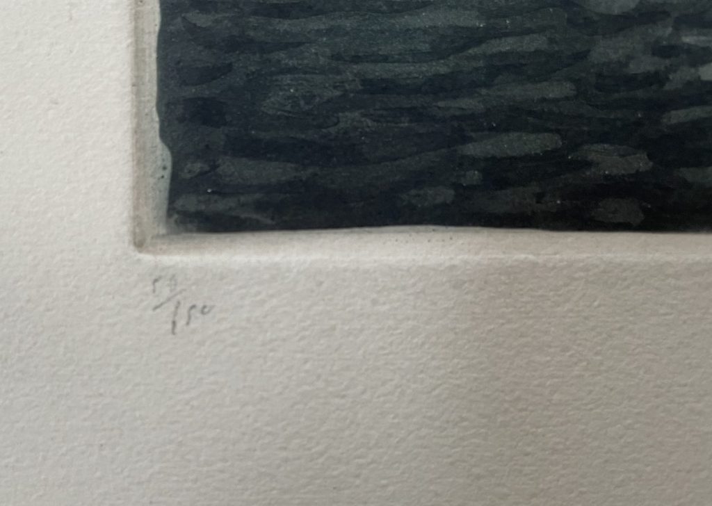 Close-up view of a signature on the bottom corner of an artwork with textured paper.