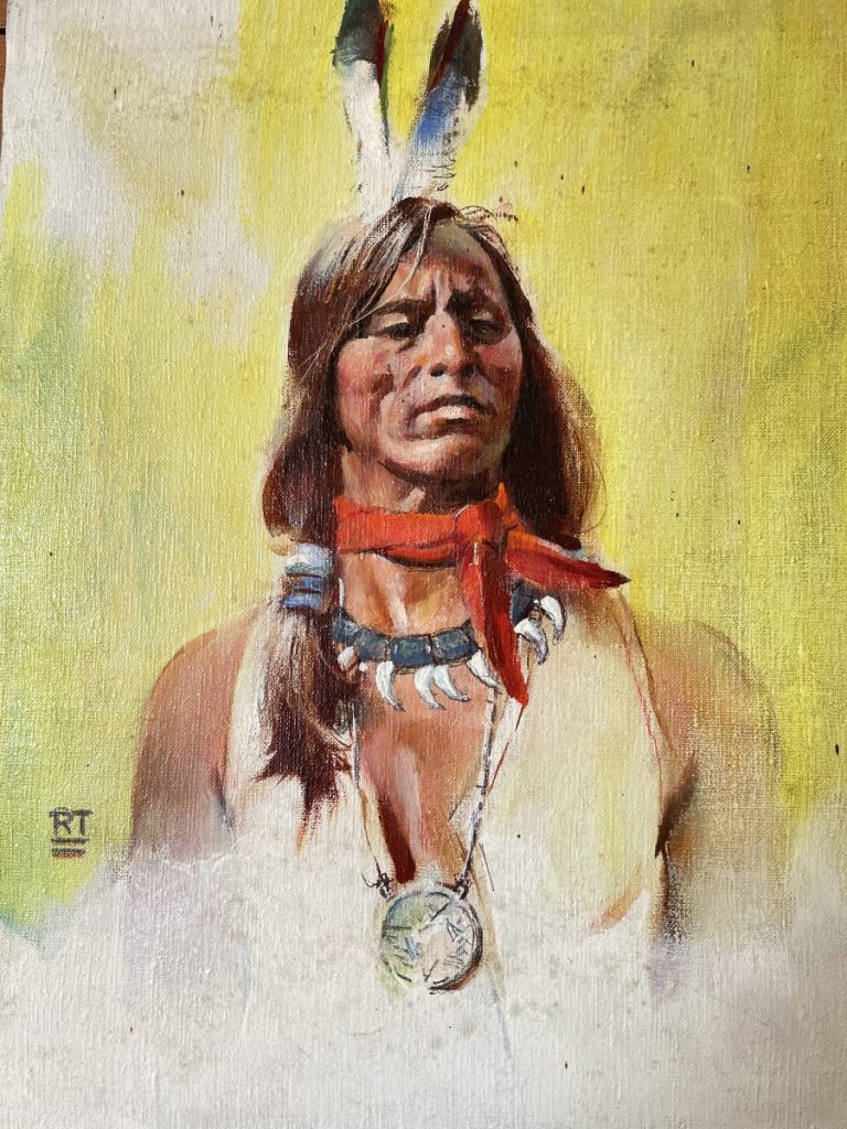 Portrait of a Native American man wearing a feathered headdress and traditional attire.