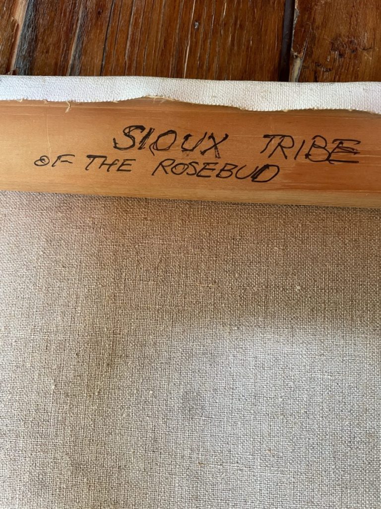 Wooden frame with handwritten inscription 'Sioux Tribe of the Rosebud' on the top edge.